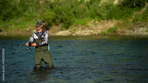 A fisherman casts his spinning rod while fishing