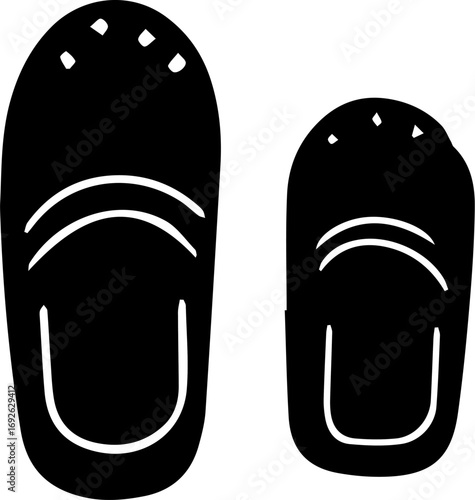 Two black flip flops with a white background. The flip flops are of different sizes, with one being larger than the other
