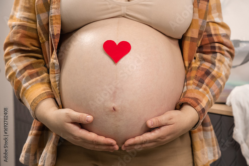 Wallpaper Mural Pregnant woman holding red heart shape and feel love for unborn baby in belly. Awaiting for baby. Concept of maternity and pregnancy care Torontodigital.ca