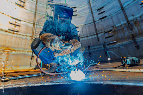 Welding male worker metal is part of machinery plate roof tank beam construction