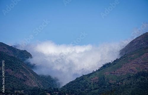 Clouds among green mountains