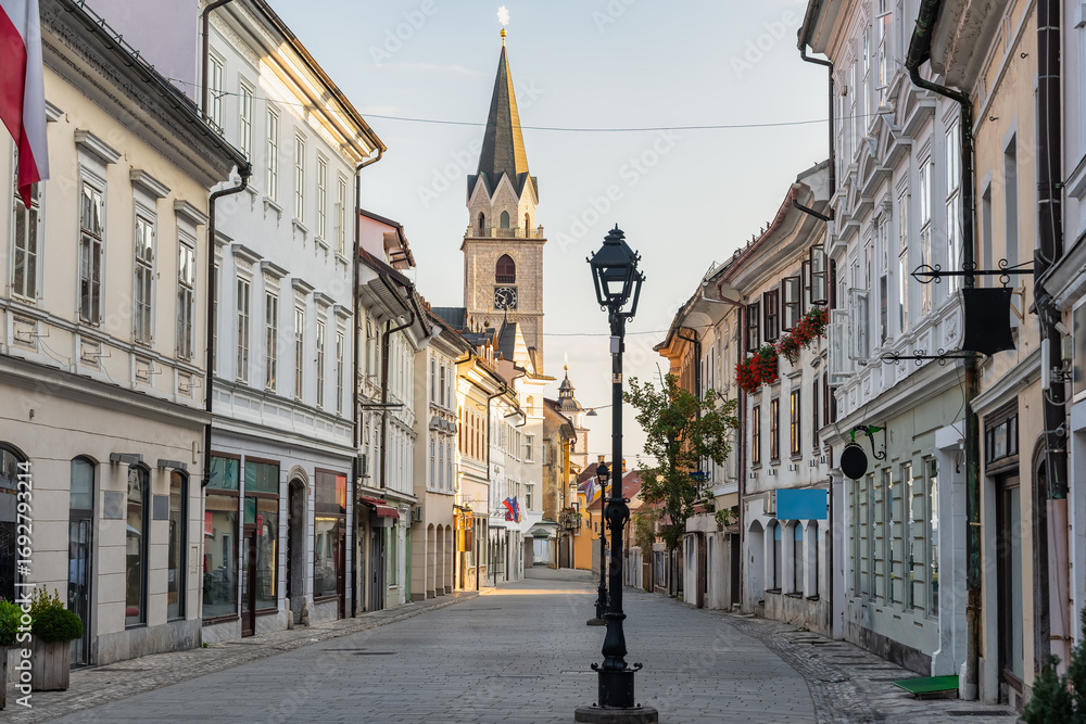 Fototapeta premium Central street of the picturesque town of Kranj with beautiful buildings and church towers, Slovenia.