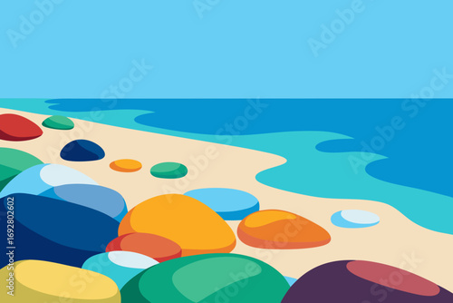 Colorful pebbles on a sandy beach with blue ocean and clear sky