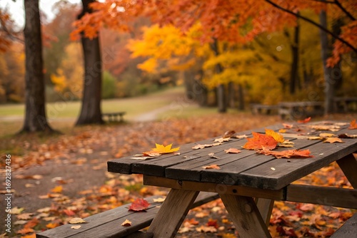 Wooden Table With Orange Laves And Blurred Autumn Bakground