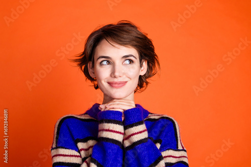 Photo of cute pretty lovely woman wear stylish clothes arms under chin look up banner news isolated on orange color background