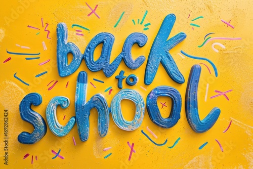 Back to school is in blue glitter on a yellow background