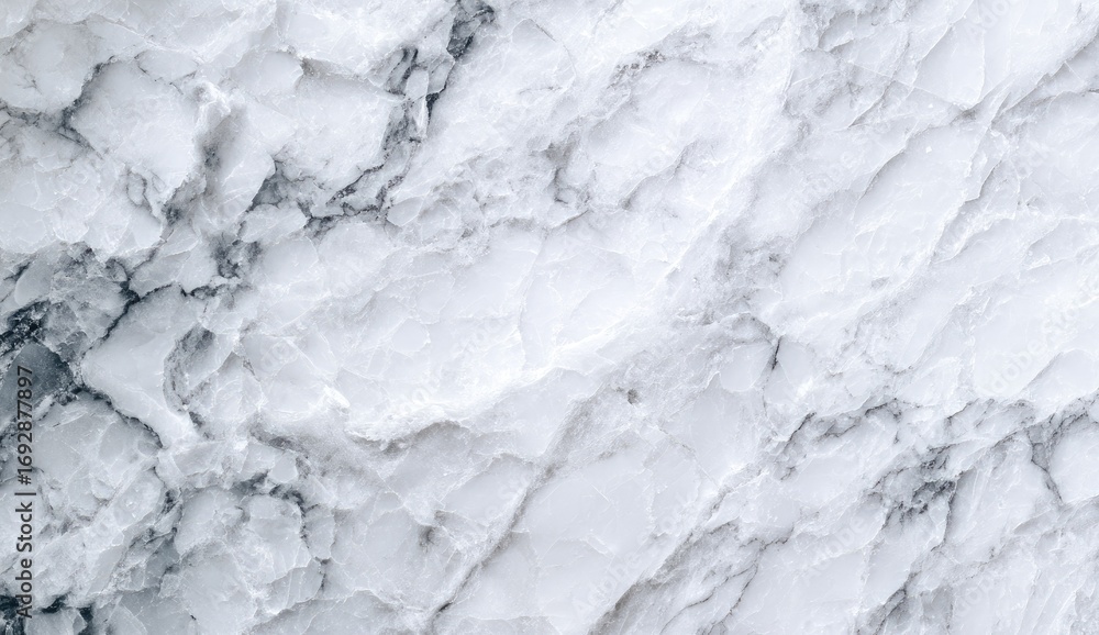 Fototapeta premium Close-up view of a textured white marble surface with subtle gray veining