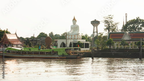 White Buddha statue in meditation by the riverside Chao Phraya river in Bangkok, Thailand