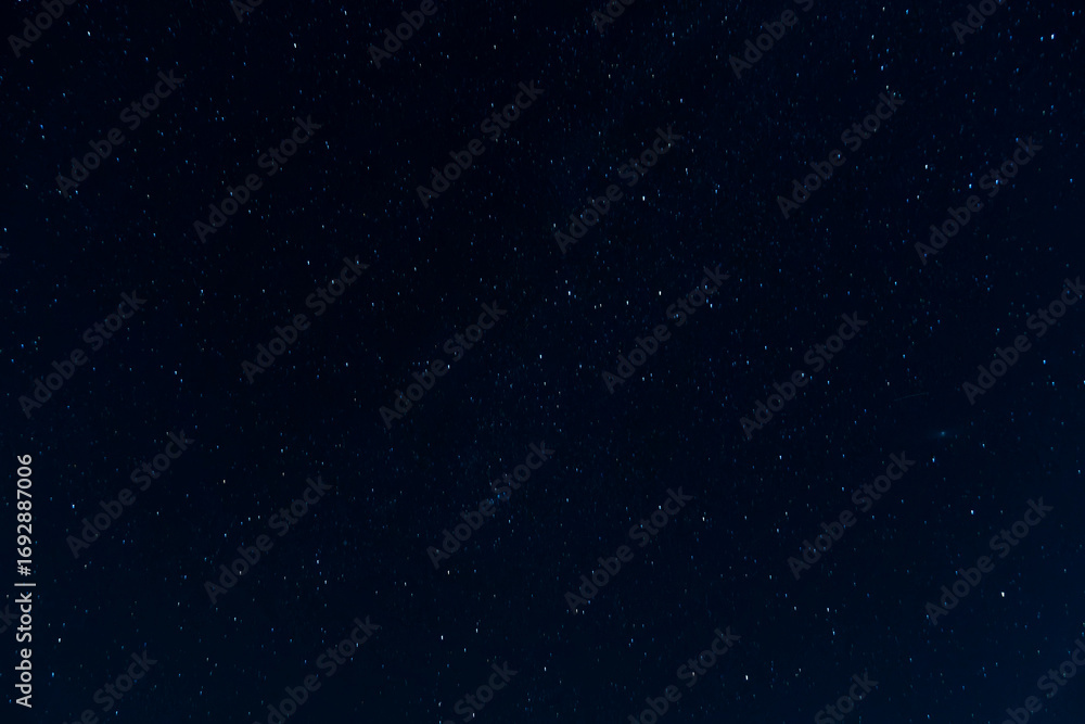 Fototapeta premium Night sky scattered stars. Celestial canvas dark blue background with glimmering star points cosmos backdrop. Deep space dreamscape infinite galaxy of hope dark blue starry sky.