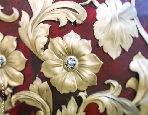 Ornate gold floral design on burgundy background