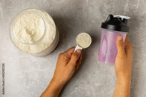 Protein powder. protein shake. Shaker bottle with protein. Food supplement. Whey protein powder with shaker for mixing. Sports nutrition. Concept of sports and healthy lifestyle. Sports equipment