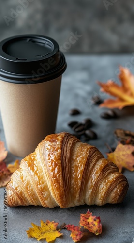 Freshly Baked Croissant With Coffee Cup and Autumn Leaves on the Table