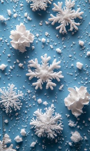 Delicate Snowflakes and Ornaments Scattered on Blue Background for Winter Dec...
