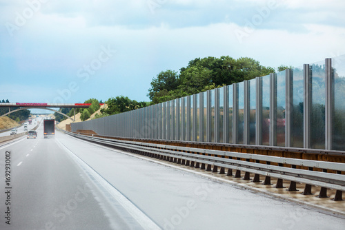 Noise Wall on Road. Sound Wall or Noise Barrier. Modern Highway and Roadside Barriers. Traffic Noise on Highway.