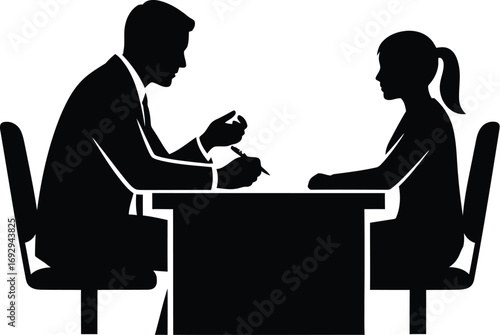 Silhouette of a job interview with a man and a woman sitting at a table, man is interviewing woman for a job position in company