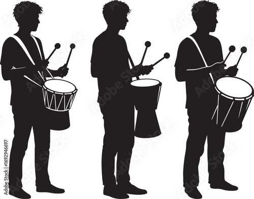 Three drummers in silhouette playing their drums in a marching band formation silhouette