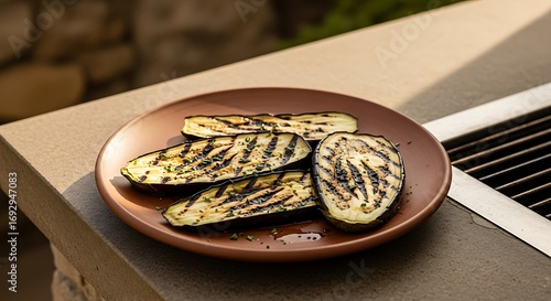 Deliciously grilled zucchini slices with dark char marks served on a rustic copper plate in a natural outdoor setting