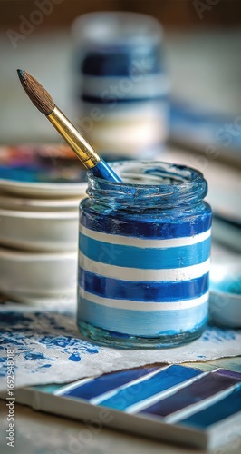Blue paint, paintbrush, and color swatches