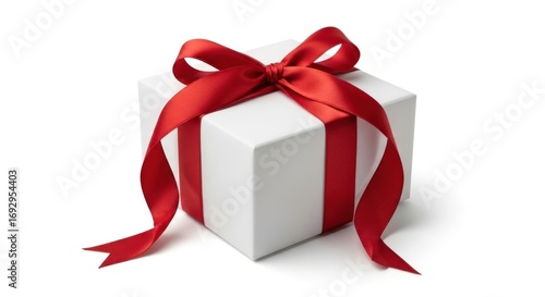 A simple white gift box elegantly wrapped with a bright red satin ribbon and tied in a classic bow on top, isolated on a white background.