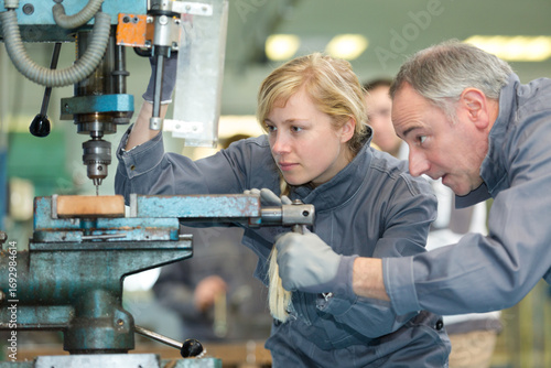 man and woman apprentice at a factory