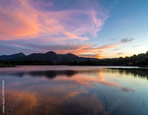 Serene sunset over tranquil lake reflecting vibrant clouds