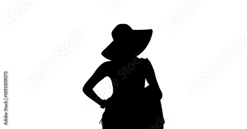 A striking silhouette of a woman wearing a wide-brimmed hat and a dress, positioned against a plain white backdrop.