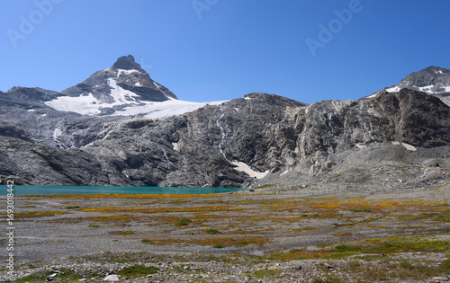The peak Granta Parey and the Goletta glacier in the Graian Alps in Italy. Glacial lake Goletta of turquoise color, fed by the melting waters of the glacier. Hiking trail from refuge Benevolo.