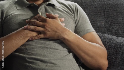 Man suffering heart attack on sofa