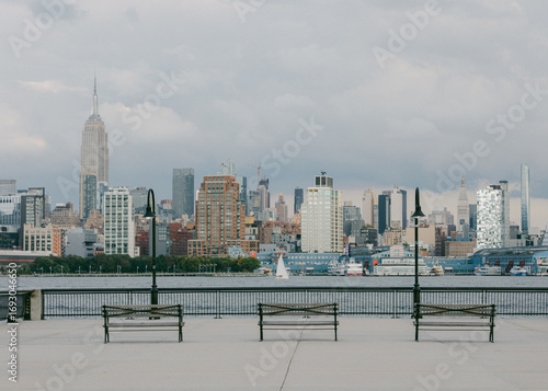 Canvas Print City skyline view with benches along the waterfront at Hudson River in New York
