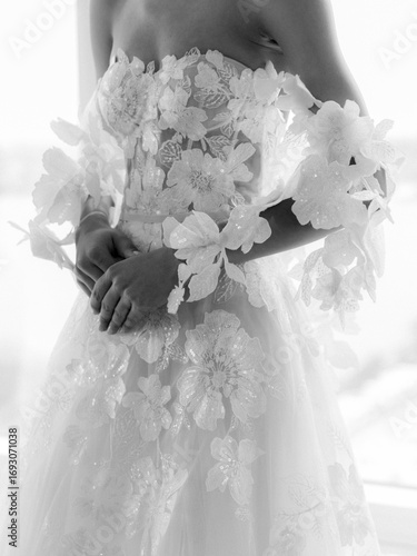 Elegant bridal gown with floral embellishments captures timeless beauty in soft light