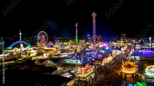 Wallpaper Mural Oktoberfest night scene with illuminated rides, colorful lights and festive crowds Torontodigital.ca