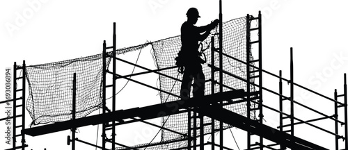Silhouette of construction worker on scaffolding, safety netting, protective gear, industrial building site, height work, urban construction safety measures.