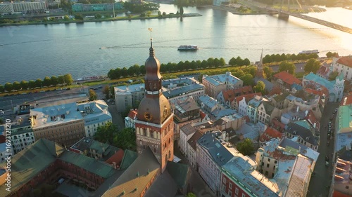 Riga, Latvia, Baltics. Beautiful panoramic aerial 4K video from flying drone to Rigas Dome Lutheran church on a summer, sunset. Old Riga in the background. (Series)
