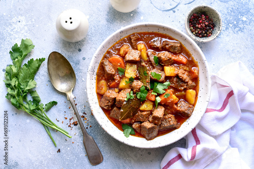 Goulash (meat stew with tomatoes and paprika) - traditional dish of hungarian cuisine .Top view with copy space.