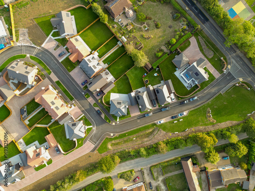 Drone top down view of newly purchased homes seen in a British housing development site. Smaller, first time buyer homes are on the left, further into the estate.