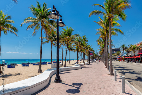 Fototapeta Naklejka Na Ścianę i Meble -  Seafront promenade and wonderful beach with palm trees on a sunny summer day in Fort Lauderdale, Florida.