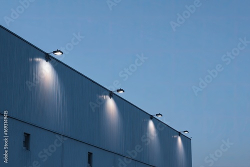 Industrial building at dusk with spotlights