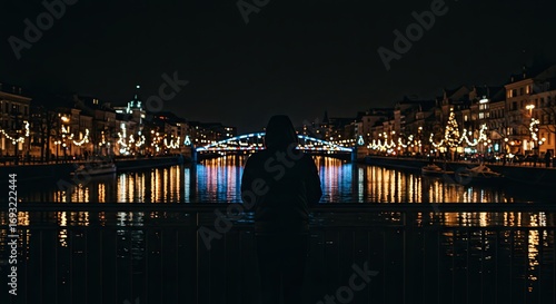Hooded Person Dark Silhouette Over River Reflecting City Lights Night