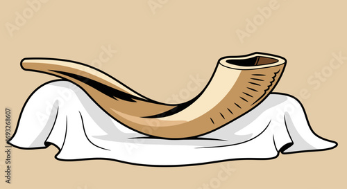 A curved, golden shofar rests on a draped white cloth against a beige background.