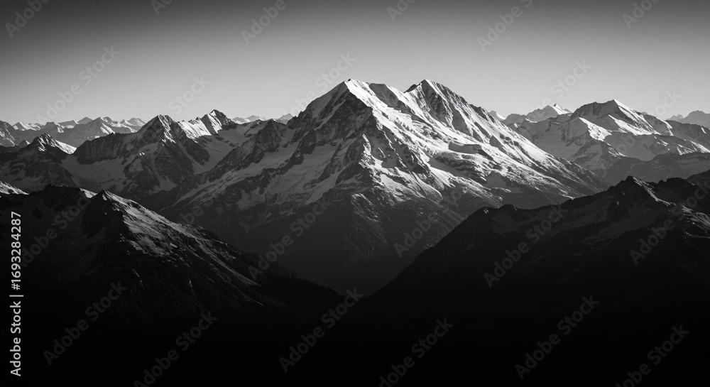Obraz premium a black and white photo of a mountain range