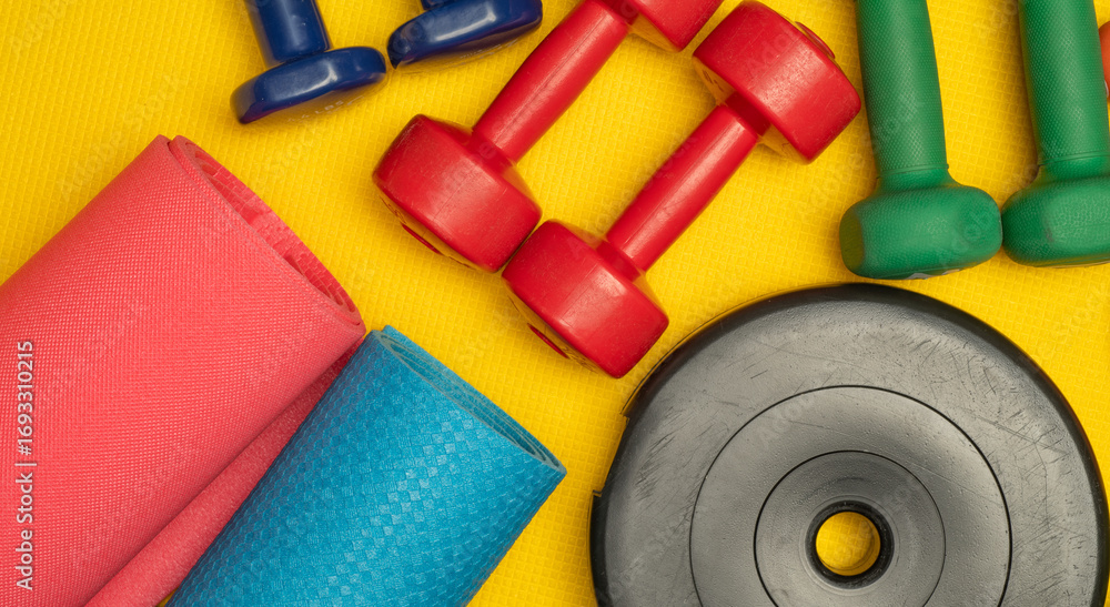 Fototapeta premium colored background with fitness accessories