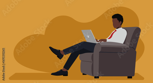 Professional man works on a laptop from a comfortable armchair, highlighting remote productivity and modern business lifestyle.