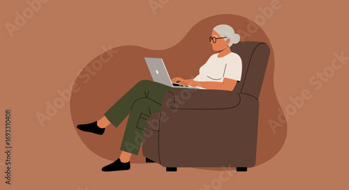 Elderly woman comfortably working or learning on a laptop in an armchair at home, showcasing digital connectivity and modern lifestyle.