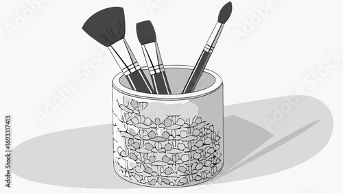 Three makeup brushes in a patterned holder.