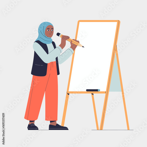 A woman in a hijab stands next to a blank easel, wearing casual clothes, preparing to write, symbolizing education and engagement in a teaching environment.