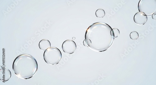 Clear, round soap bubbles floating in a light gray background, creating a flowing pattern.