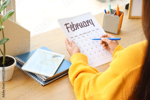 Woman marking day on flip c...