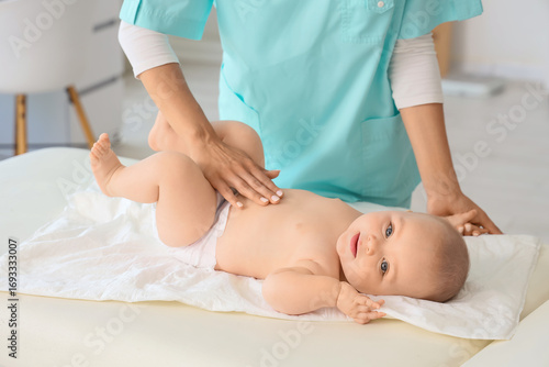 Female therapist massaging ...