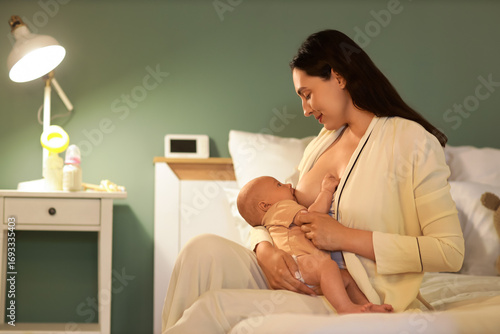 Young woman breastfeeding h...
