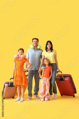 Family of tourists with sui...